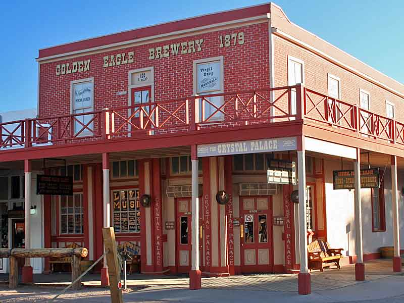 Historic red brick building with 'Golden Eagle Brewery 1879' sign, featuring a balcony and ground floor entrance labeled 'The Crystal Palace'. Western-style architecture with wooden posts and railings.