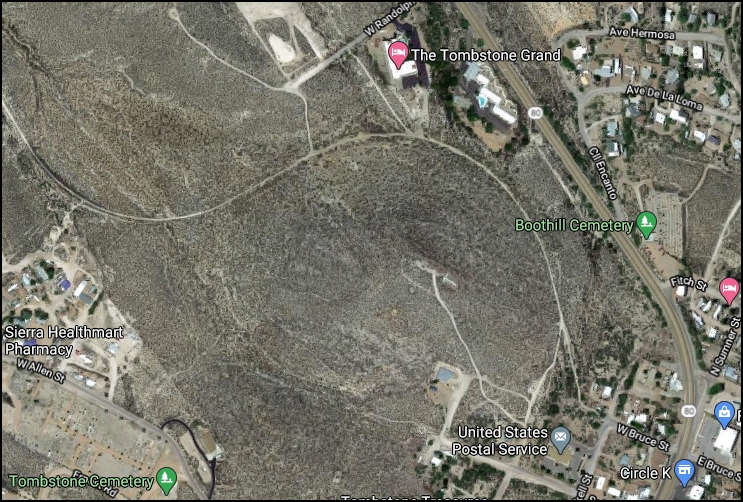 Satellite view of Tombstone, Arizona, showing Boothill Cemetery, Tombstone Grand hotel, and surrounding desert landscape with scattered buildings and roads. The old railroad grade is visible as a loop around the center of the image.